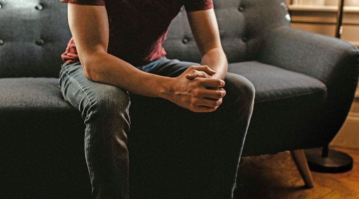 Man reflecting sitting on sofa during therapy