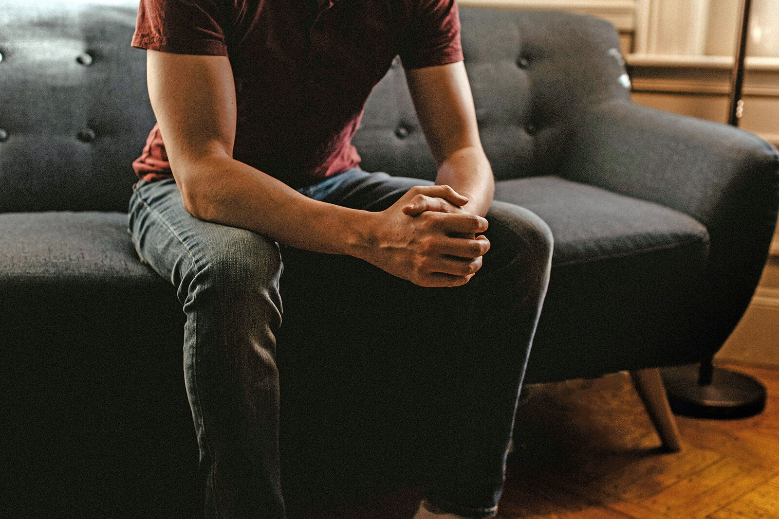 Man reflecting sitting on sofa during therapy